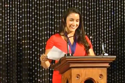 Photo shows Aly Raisman speaking in 2013 at her Hall of Fame induction